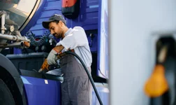 man fueling up a truck